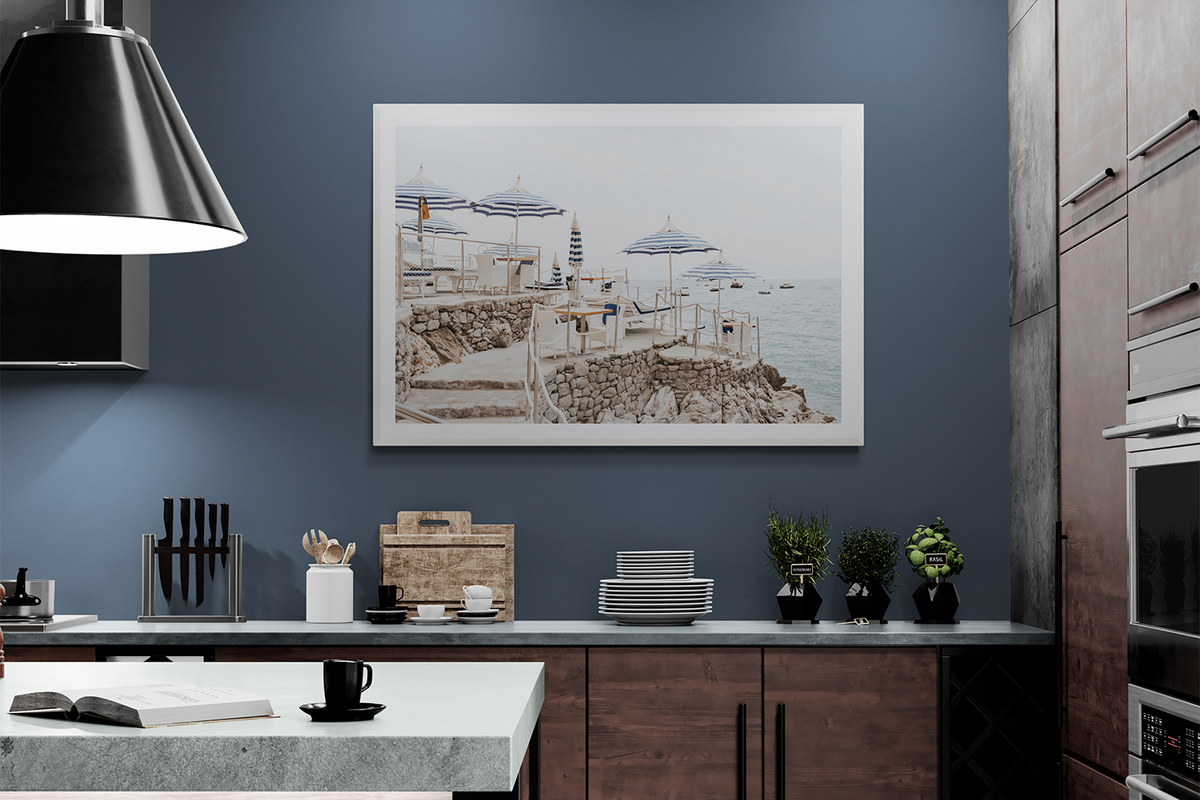 Ombrelloni Positano fine art print in a white frame styled in a navy kitchen
