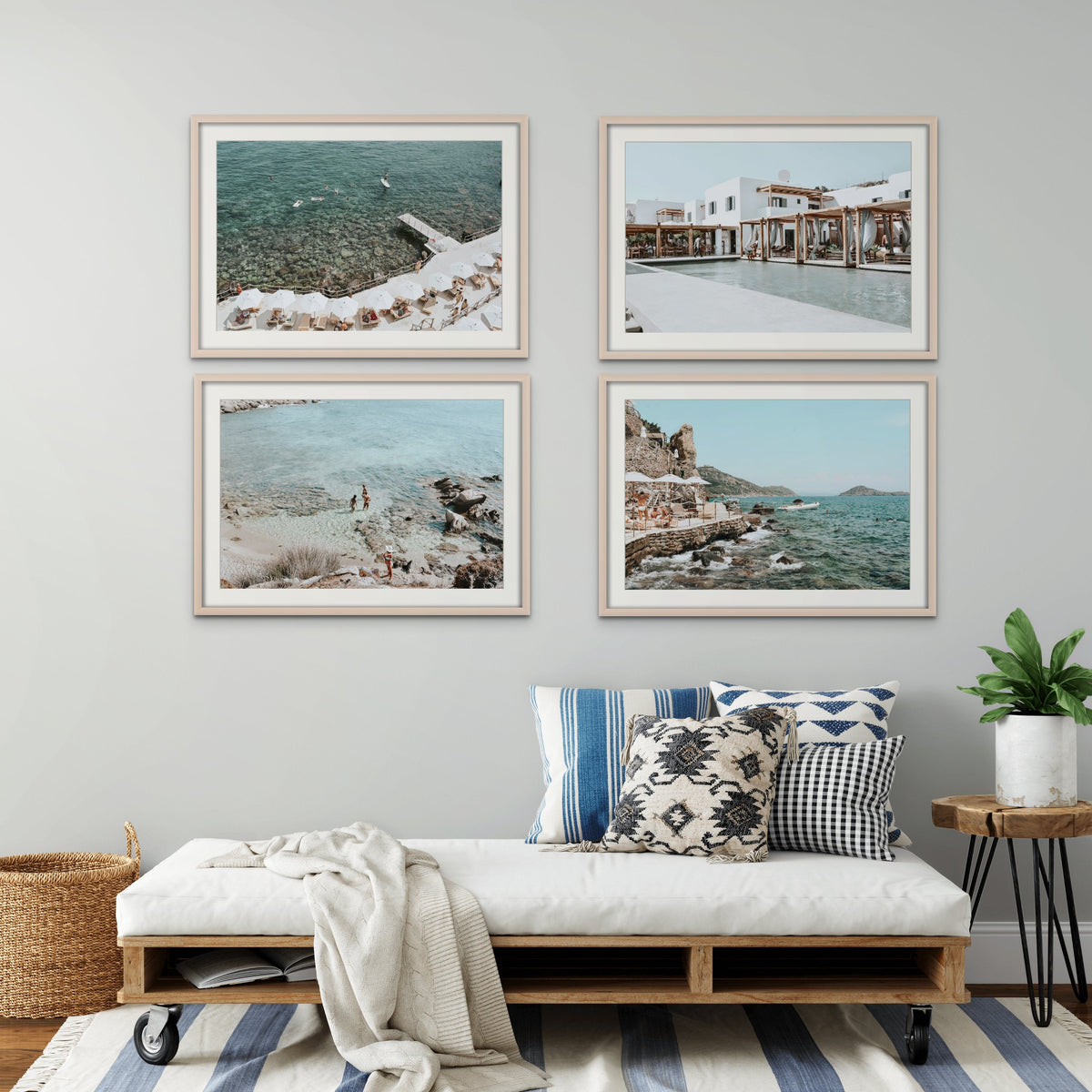 Four framed travel photographs grouped above a neutral sofa