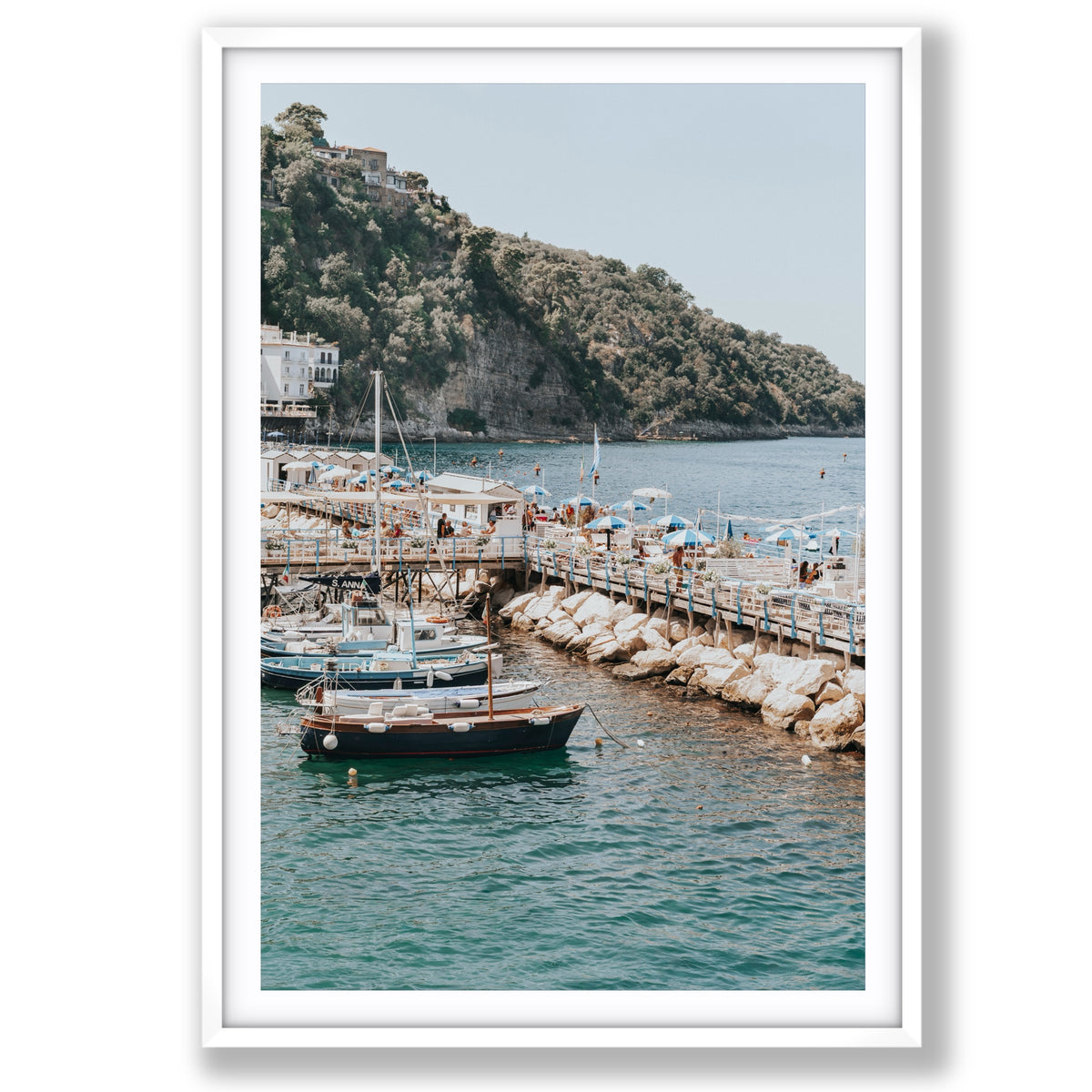 Sundeck Society Sorrento, beach club sundeck, blue umbrellas and moored boats below cliff, main fine art print image