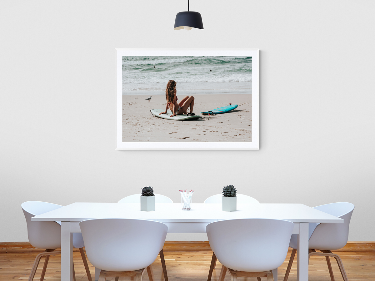 Carissa fine art print in a white frame styled above a white dining table