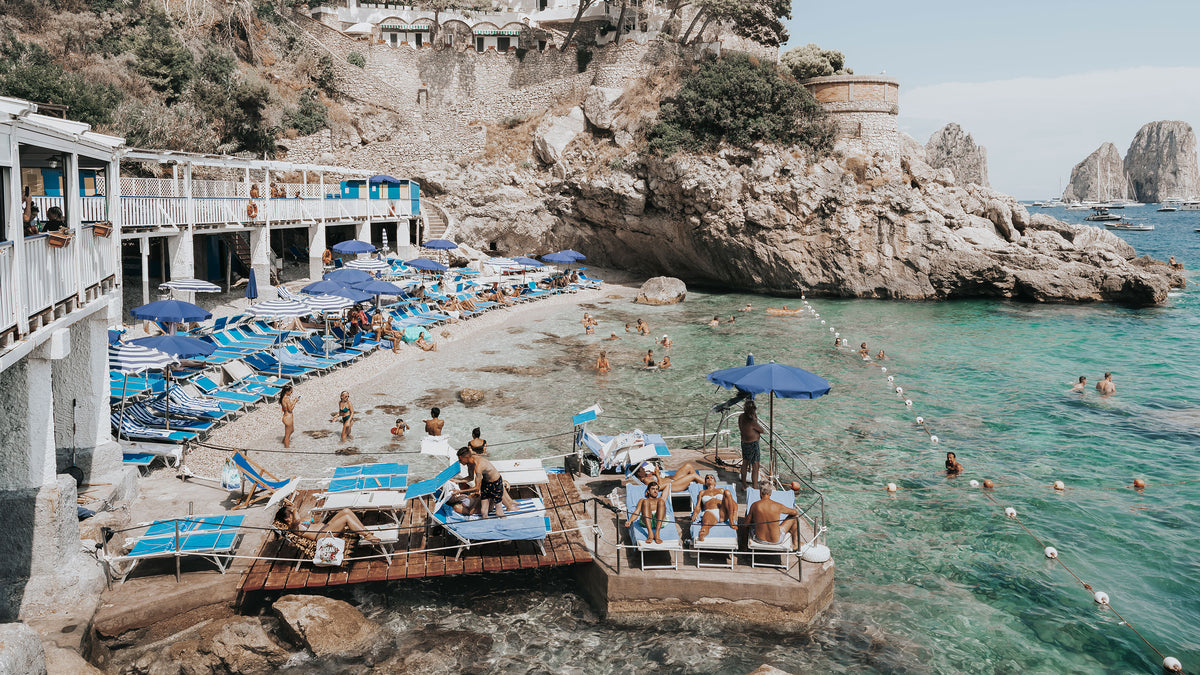 New wall art prints: Vita Bella, a Capri fine art photography print of a sunlit beach club below the cliffs by Amichi Co