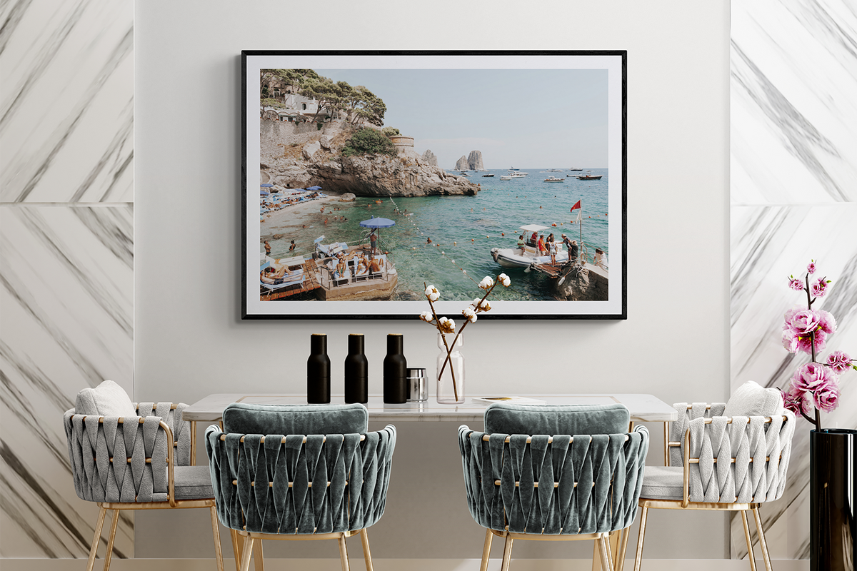 Torre Saracena Capri fine art print in a black frame above a marble dining table in an Italian interior