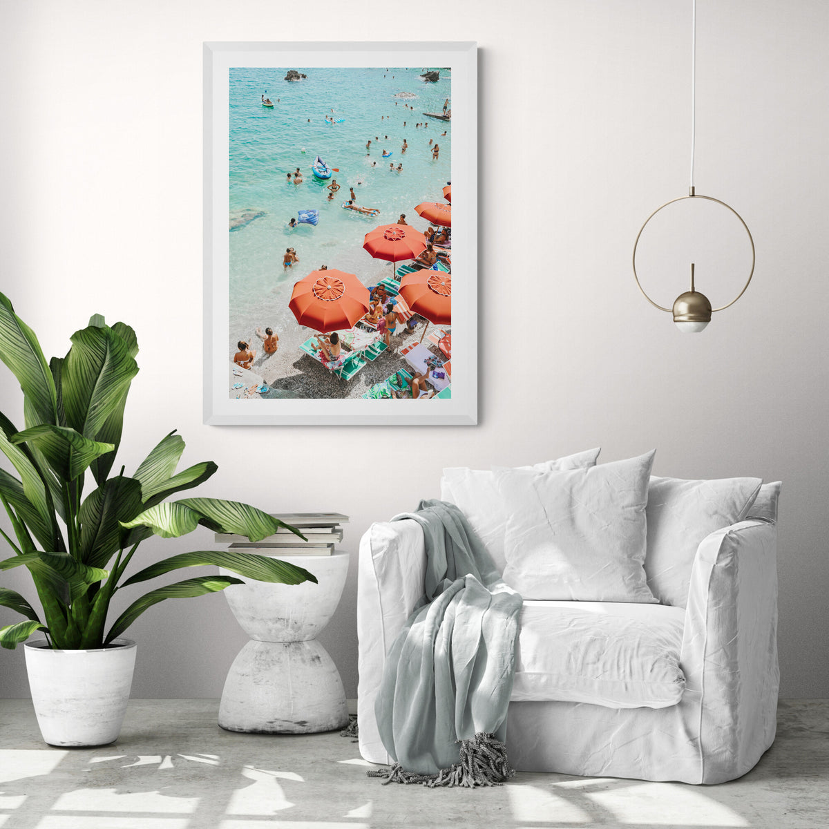 Easy Street Capri fine art print in a white frame above a white linen sofa with a brass ring pendant