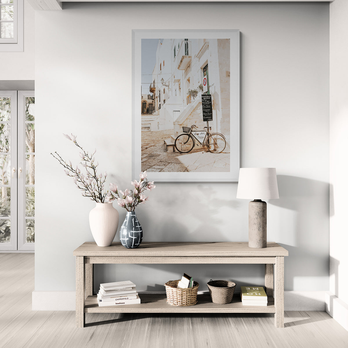 La Bicicletta Puglia fine art print in a white frame, styled above a pale timber console in a bright hallway