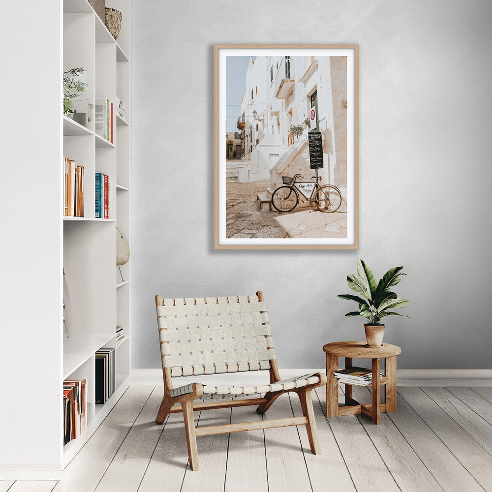 La Bicicletta Puglia Ostuni wall art natural oak framed print styled in a room
