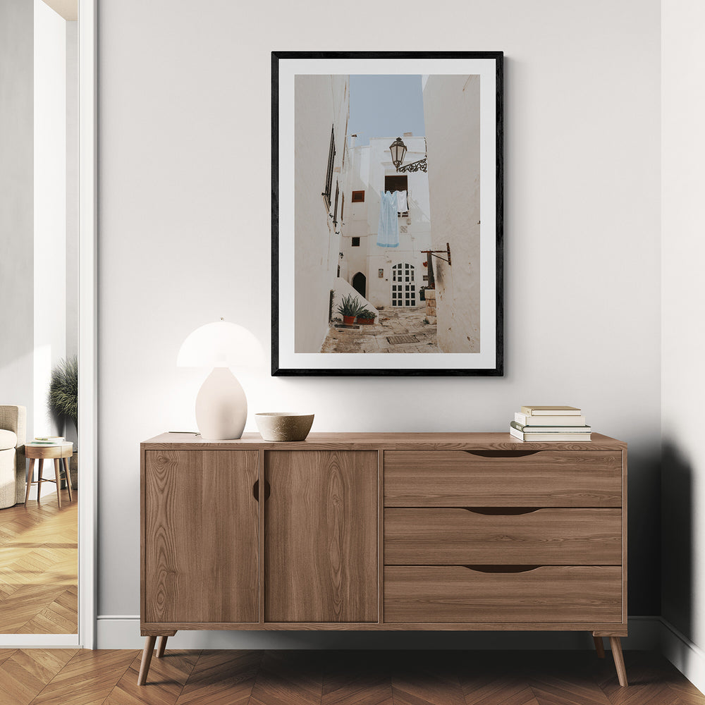 Laundry Day Puglia Ostuni Italian wall art black framed print styled in a room