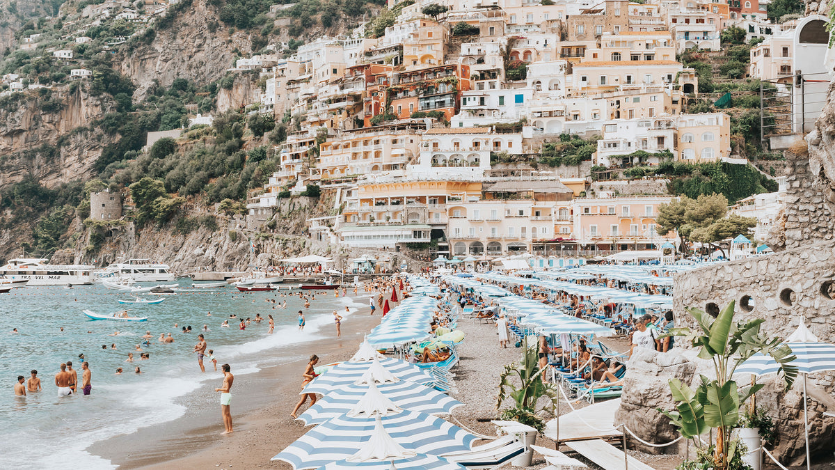 Pastel houses of Positano stacked above the beach umbrellas of Spiaggia Grande