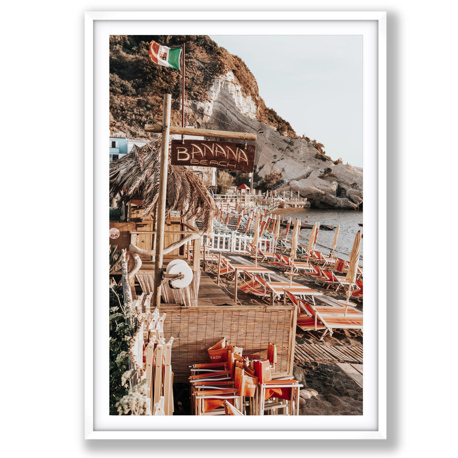 Barefoot Ischia Ischia, Banana Beach sign, striped loungers and stacked orange chairs, main fine art print image