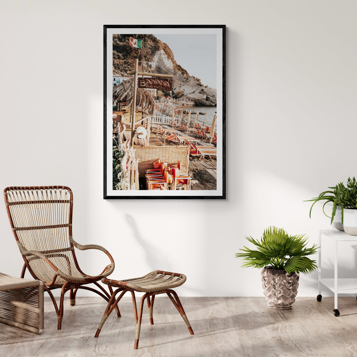 Barefoot Ischia Ischia, Banana Beach sign, striped loungers and stacked orange chairs, framed print styled in a room view 5