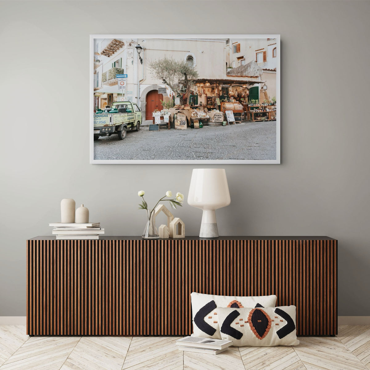 Mercatino Ischia, cobbled street market stall with olive tree and green truck, framed print styled in a room view 6