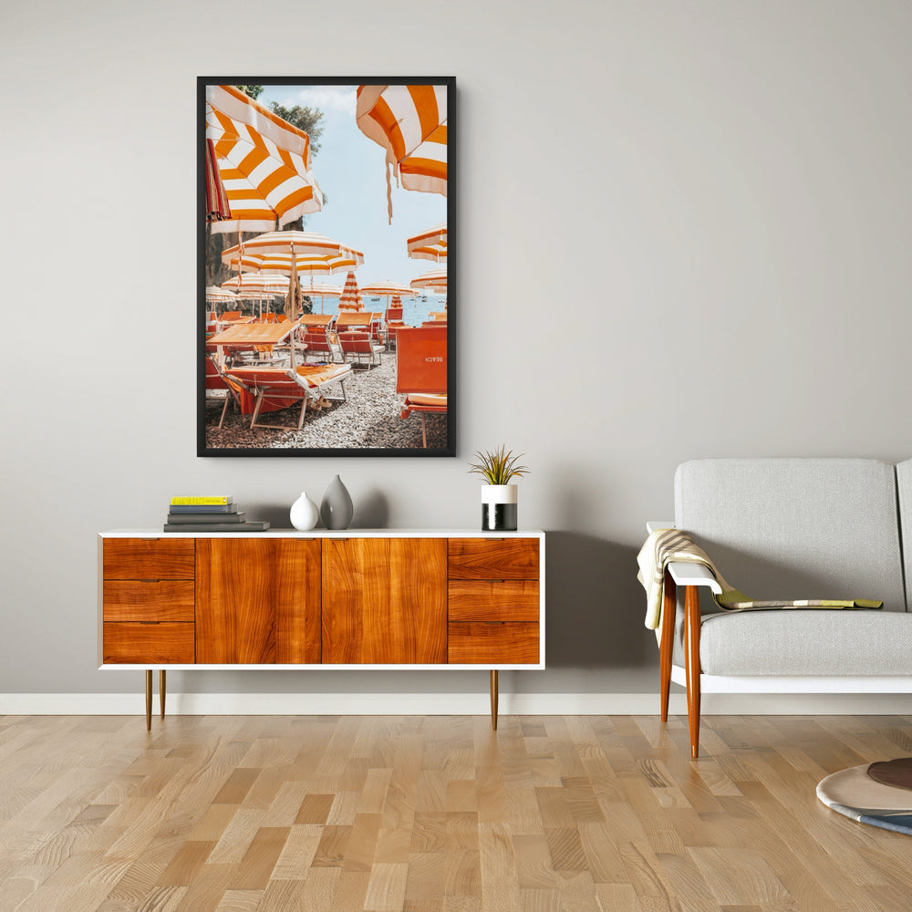 Aperol Summer Positano, orange striped parasols and loungers on a Positano pebble beach, framed print styled in a room view 2