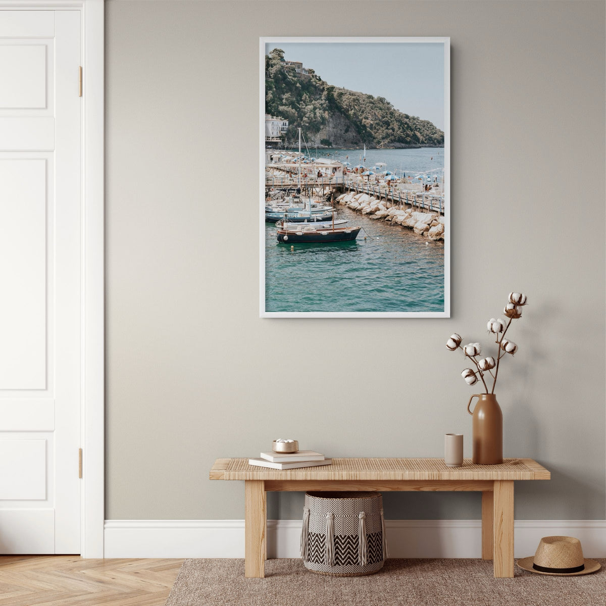 Sundeck Society Sorrento, beach club sundeck, blue umbrellas and moored boats below cliff, framed print styled in a room